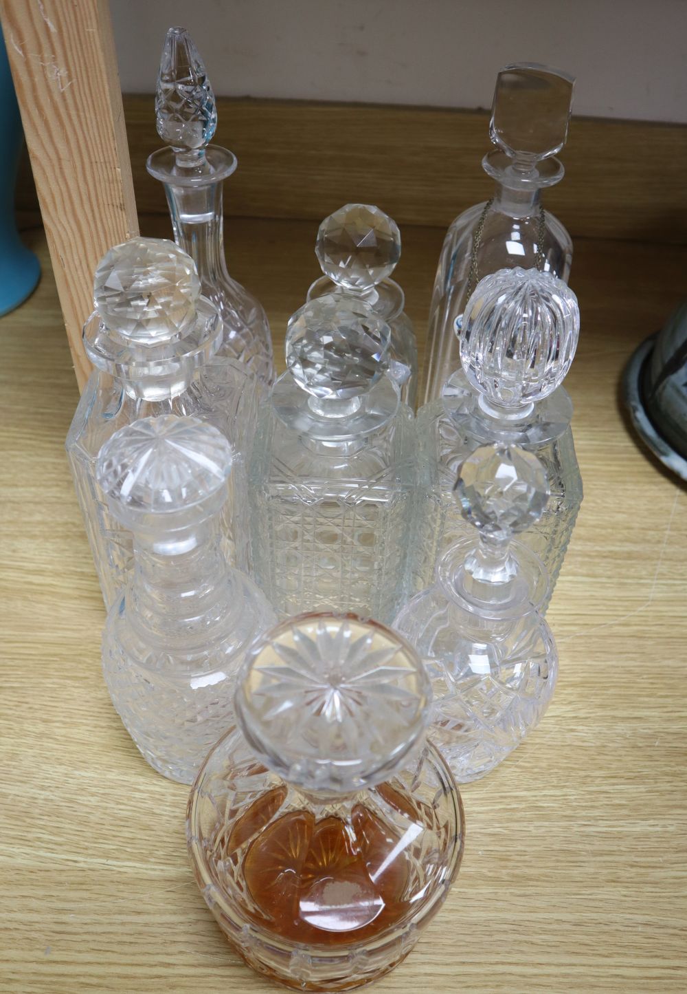 Nine various cut and mounted glass decanters and stoppers and two gin labels